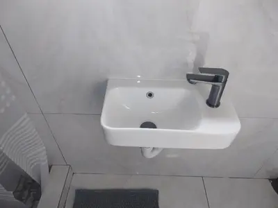 a white sink with a faucet in a bathroom at 160 On Townsend Guesthouse in Cape Town