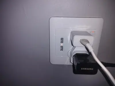 a charger with a cord plugged into an electrical outlet at 160 On Townsend Guesthouse in Cape Town