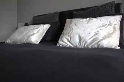 two pillows sitting on top of a bed at Charming Modern Bedsitter in Cape Town