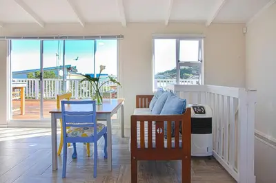 a dining room with a table and chairs at Beautiful family beach cottage! in Pringle Bay
