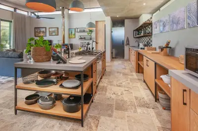 a large kitchen with a counter with pots and pans at Villetta in Mosselrivier