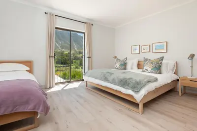 a bedroom with a bed and a large window at Casa La Vita in Hermanus