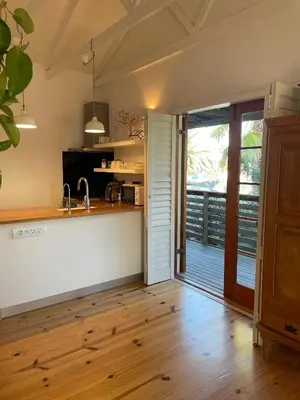 a kitchen with a sink and a counter top at Sunset Beach Studio Apartment in Cape Town