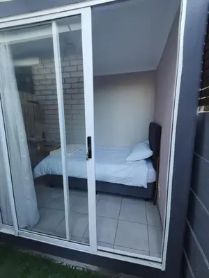 a room with a glass door with a bed inside at Cozy Business overnighter in Bellville