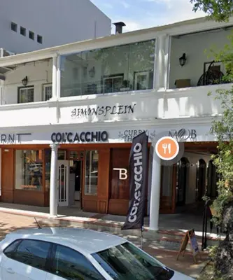 a car parked in front of a building at Modern Central 1 BR Apartment in Stellenbosch