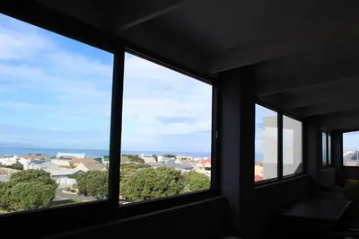 three windows in a room with a view of houses at 17 Suikerbossie in Hermanus