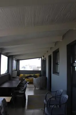 a living room with a couch and chairs at 17 Suikerbossie in Hermanus