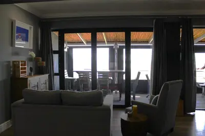 a living room with a couch and a dining room at 17 Suikerbossie in Hermanus