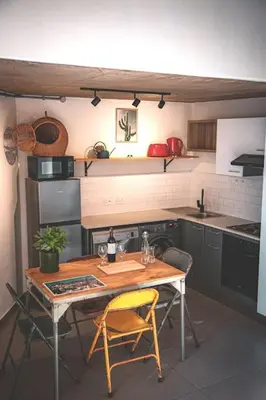 a kitchen with a table and two chairs and a table and a table at Kape Loft in Cape Town