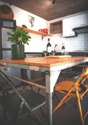 a table in a kitchen with a potted plant on it at Kape Loft in Cape Town