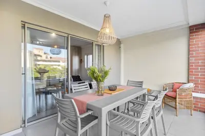 a dining room with a table and chairs at Mayfair 246 by Host Agents in Cape Town
