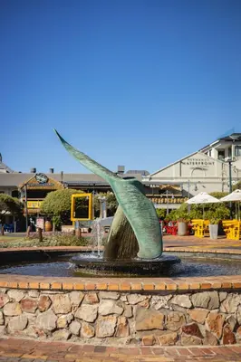 a statue in the middle of a fountain at Sea-View Studio - Hermanus Waterfront Apartments in Hermanus