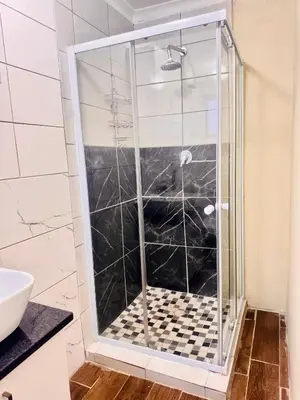 a shower with a glass door in a bathroom at Greens Haven, Your Private escape in Cape Town in Cape Town