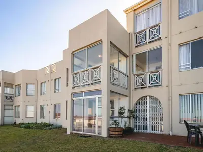 an exterior view of a building with large windows at Coastal Living in Hermanus