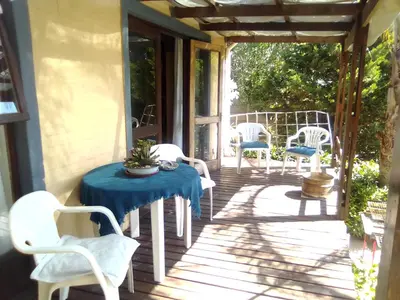 a porch with a table and chairs on it at Erf 473 Fisherhaven in Fisherhaven