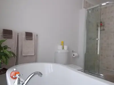 a bathroom with a tub and a shower and a toilet at Erf 473 Fisherhaven in Fisherhaven