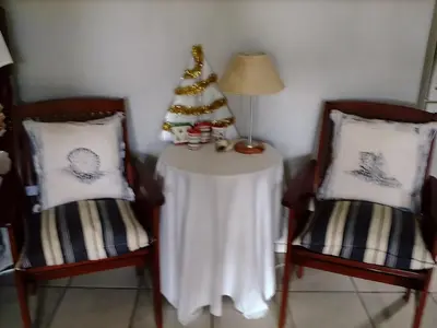a table with a christmas tree and two chairs at Erf 473 Fisherhaven in Fisherhaven
