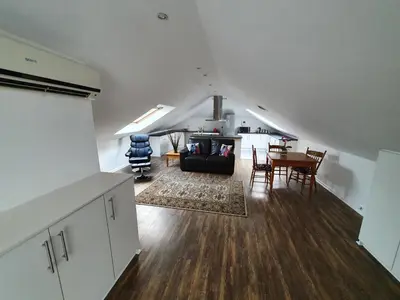 a living room with a couch and a table at Woodbridge Lodge in Cape Town