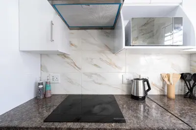 a kitchen with a counter top with a kettle on it at Affordable Luxury in Cape Town