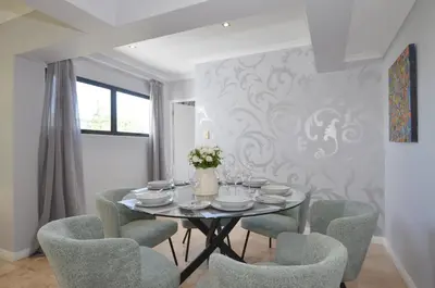 a dining room with a table and chairs at Church View Lux Apartment in Stellenbosch