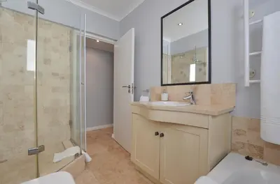 a bathroom with a sink and a shower at Church View Lux Apartment in Stellenbosch
