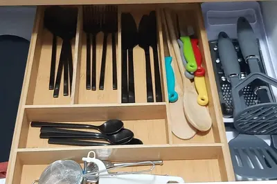 a wooden drawer filled with knives and utensils at Convenient Comfort in Cape Town