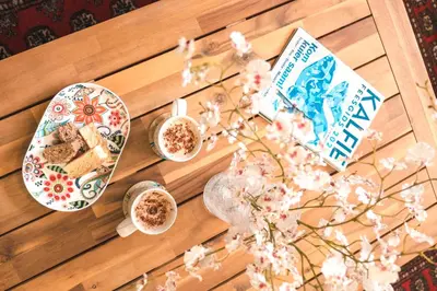 a table with plates of food and cups of coffee at Hermanus Reefs in Hermanus
