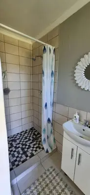 a bathroom with a shower and a sink at 4859 Lakeside in Bettyʼs Bay