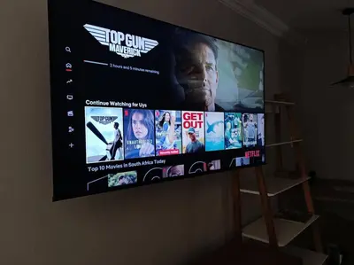 a large flat screen tv hanging on a wall at #Spacious Cozy Stay- Free parking in Stellenbosch