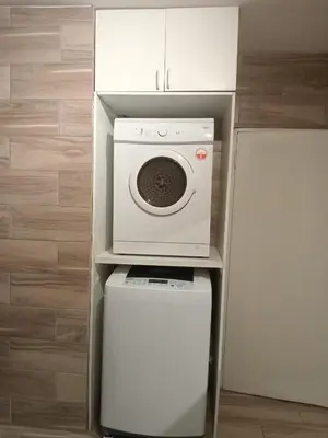 a microwave oven sitting on top of a washing machine at Sea View Serenity on Strand in Cape Town