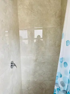 a bathroom with a shower with a glass door at 22clyde street bostin in Cape Town