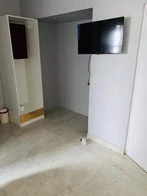 a room with a flat screen tv on a wall at 22clyde street bostin in Cape Town