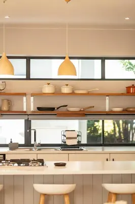 a kitchen with a counter and some windows at Bikini House - With Pool in Hermanus