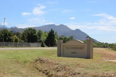 a sign in the middle of a field next to a road at Villa Villiers in Villiersdorp