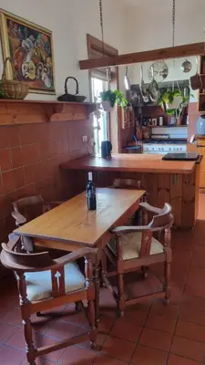 a kitchen with a wooden table and some chairs at Château Naudé in Stellenbosch Free Secure Parking in Stellenbosch