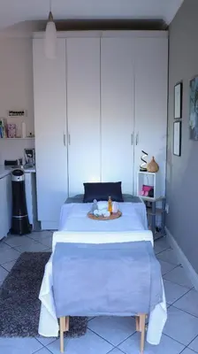 a bedroom with a bed with a plate on it at Somerset Garden Route Apartments & Wellness in Somerset West