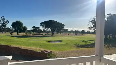 a view of a golf course from a window at Somerset Garden Route Apartments & Wellness in Somerset West