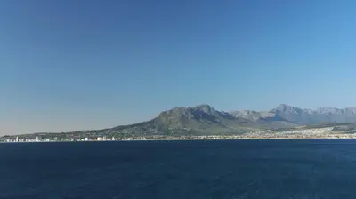 a large body of water with mountains in the background at Somerset Garden Route Apartments & Wellness in Somerset West