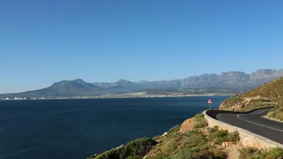 a winding road next to a body of water at Somerset Garden Route Apartments & Wellness in Somerset West