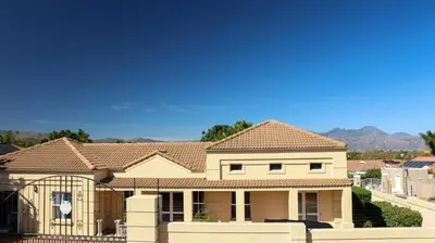 a house with a fence in front of it at Somerset Garden Route Apartments & Wellness in Somerset West