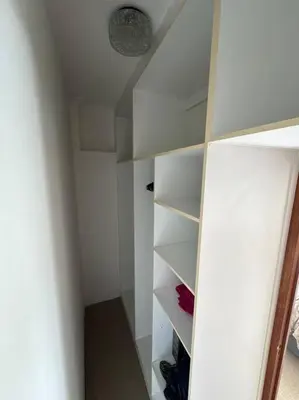 a closet with white shelves in a room at B Shocked Manor - Lux Suites in Cape Town