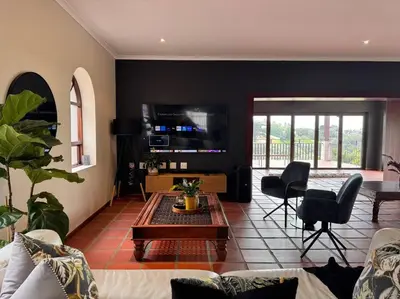 a living room with a couch and a table at B Shocked Manor - Lux Suites in Cape Town