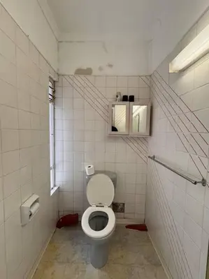 a small bathroom with a toilet and a window at B Shocked Manor - Lux Suites in Cape Town
