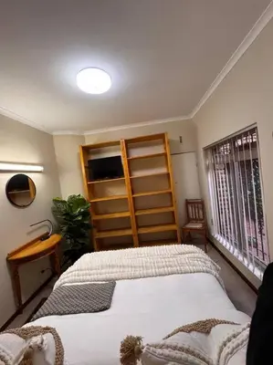 a bedroom with a large bed and a window at B Shocked Manor - Lux Suites in Cape Town