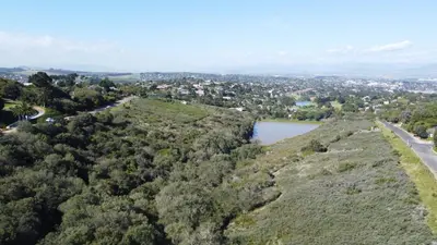 an aerial view of a hill with a road and a lake at B Shocked Manor - Lux Suites in Cape Town