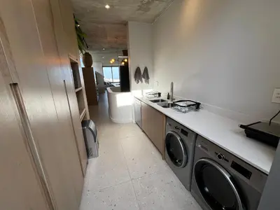 a laundry room with a washer and dryer at The Hermanus Retreat in Hermanus