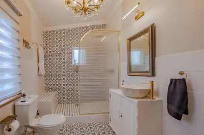 a bathroom with a sink and a toilet and a mirror at Blue Bell in Hermanus