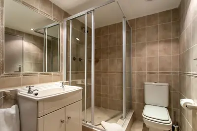 a bathroom with a toilet and a sink and a shower at Bayview 307 in Hermanus
