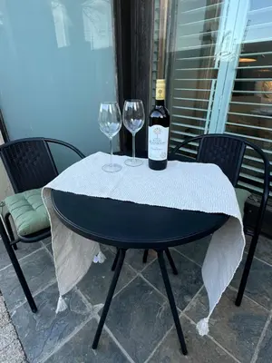 a bottle of wine sitting on a table with two wine glasses at Luxury Vineyard Suites in Cape Town