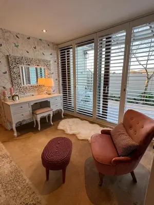 a living room with a desk and a chair at Luxury Vineyard Suites in Cape Town